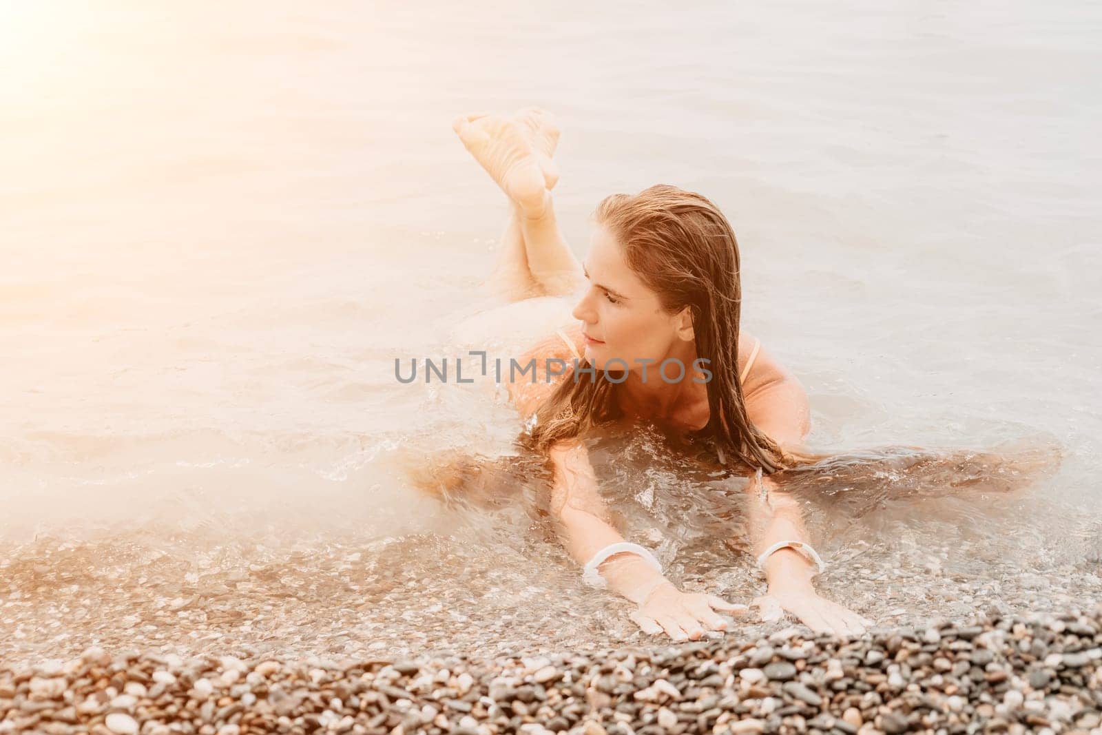 Woman travel sea. Happy tourist in hat enjoy taking picture outdoors for memories. Woman traveler posing on the beach at sea surrounded by volcanic mountains, sharing travel adventure journey by panophotograph