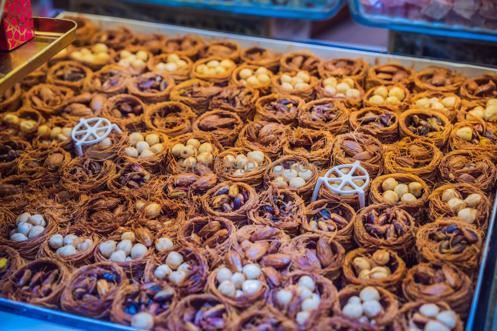 Traditional oriental sweet pastry cookies, nuts, dried fruits, pastilles, marmalade, Turkish desert with sugar, honey and pistachio, in display at a street food market by galitskaya