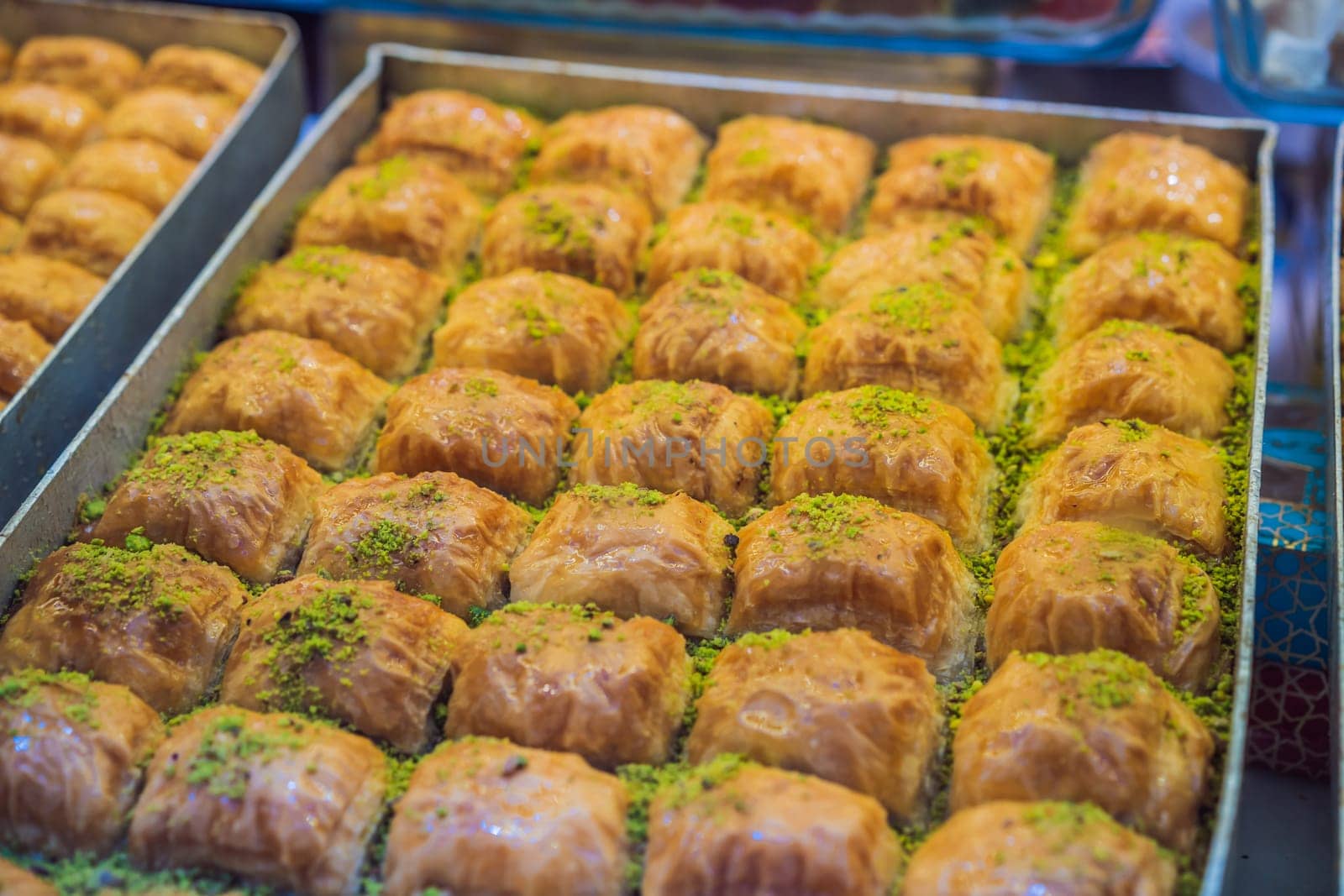 Traditional oriental sweet pastry cookies, nuts, dried fruits, pastilles, marmalade, Turkish desert with sugar, honey and pistachio, in display at a street food market.