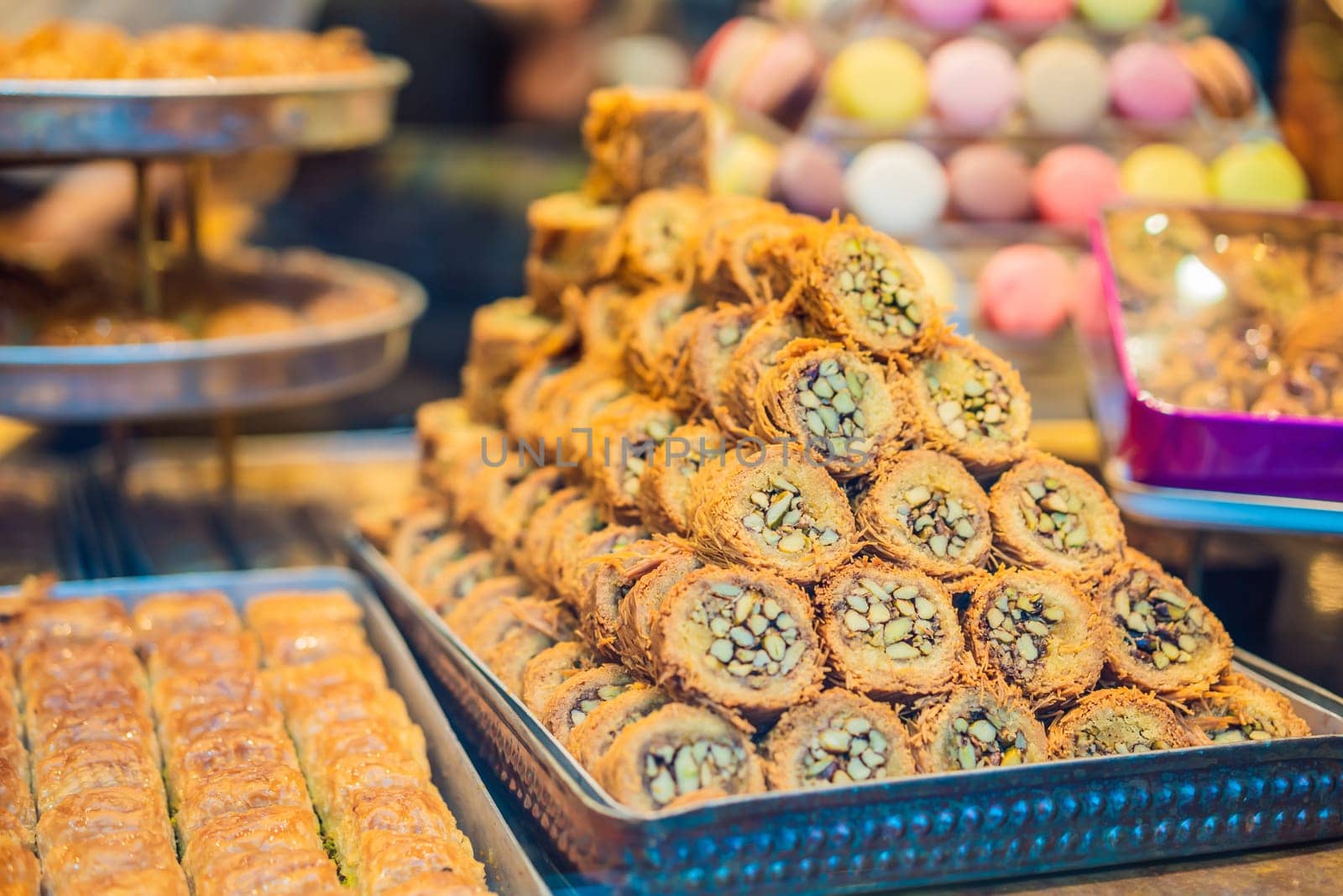 Traditional oriental sweet pastry cookies, nuts, dried fruits, pastilles, marmalade, Turkish desert with sugar, honey and pistachio, in display at a street food market.