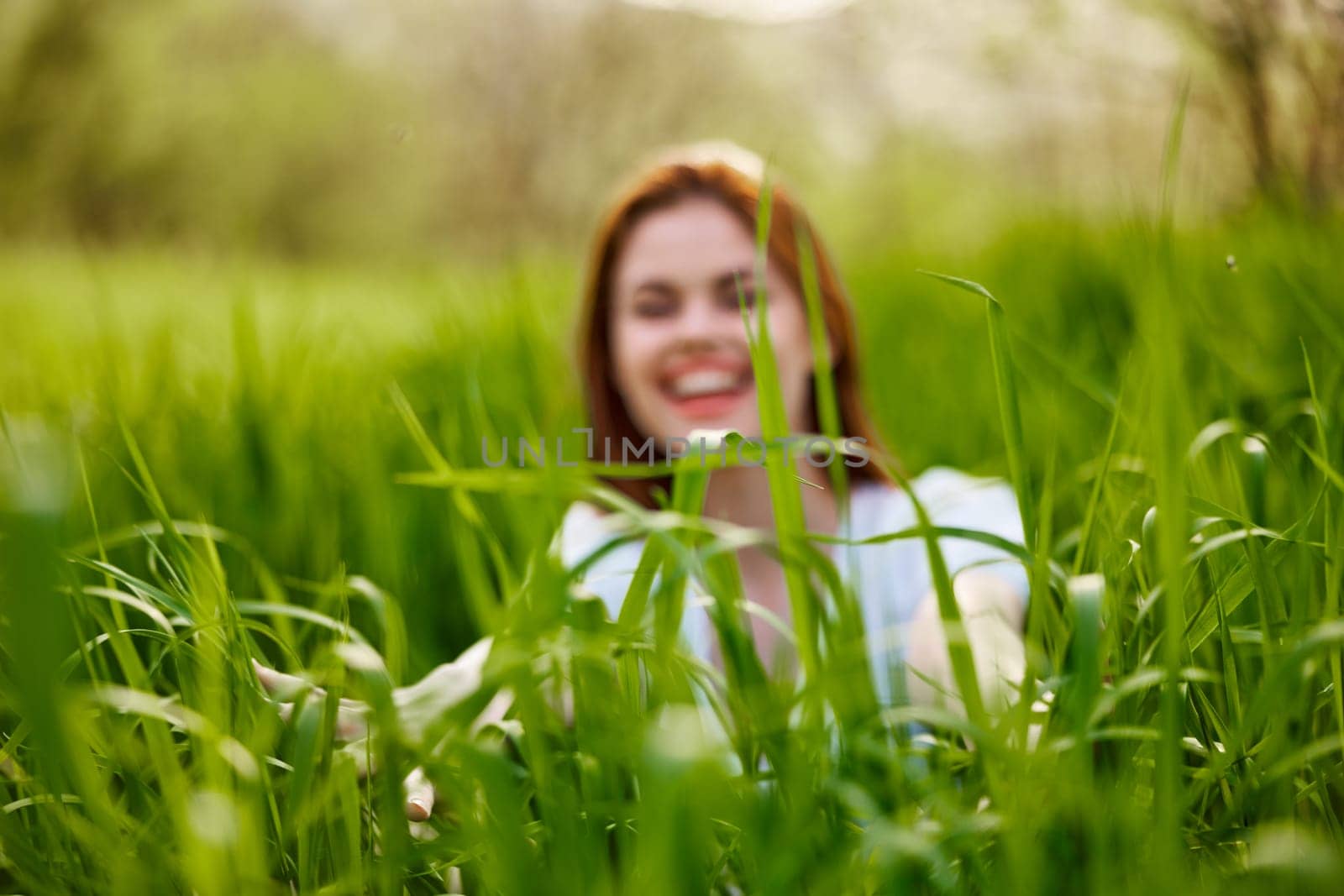 silhouette of a woman walking in tall grass. Photo out of focus. High quality photo