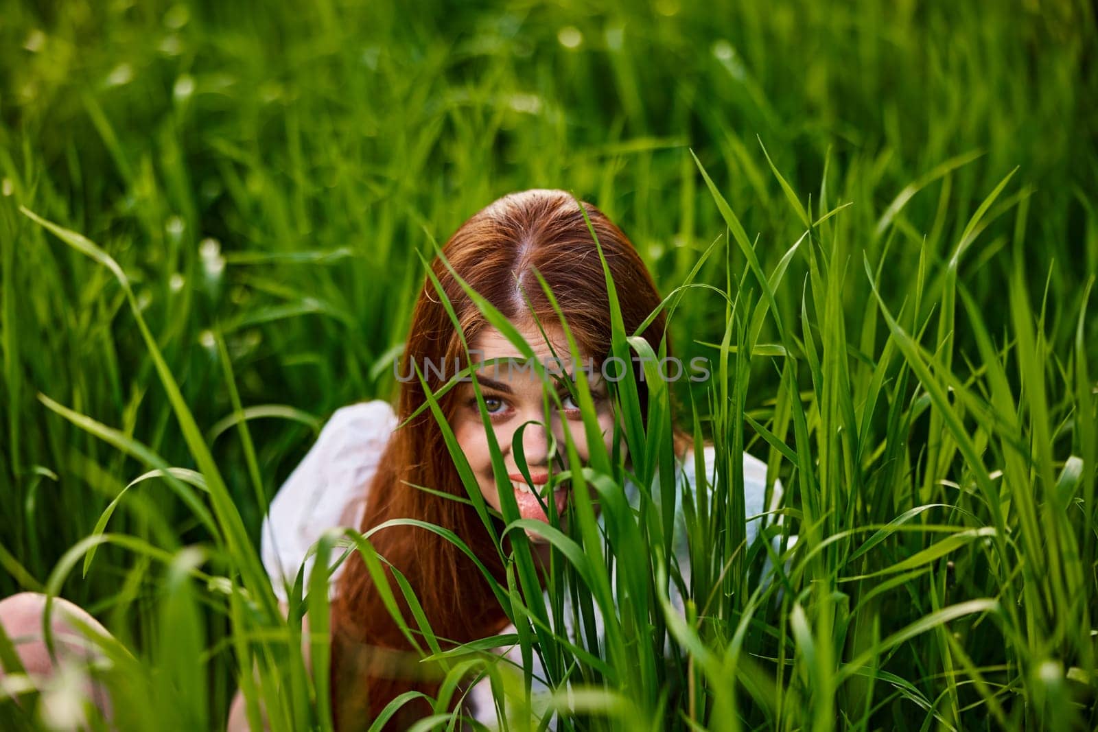 funny woman hiding in tall green grass by Vichizh