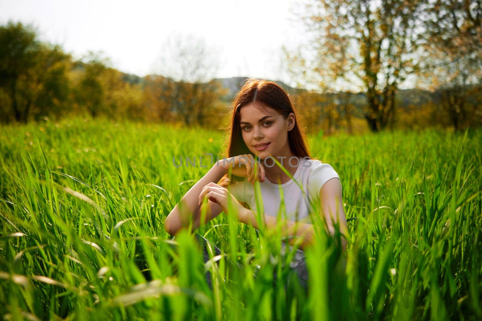 Beautiful healthy Young Woman relaxing on the green grass by Vichizh