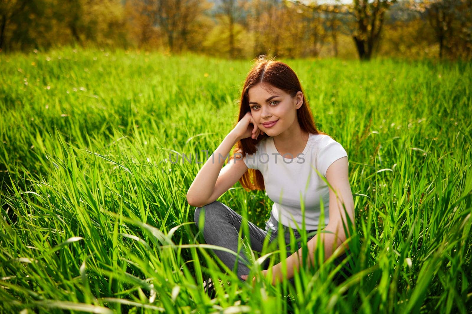 Beautiful healthy Young Woman relaxing on the green grass. High quality photo