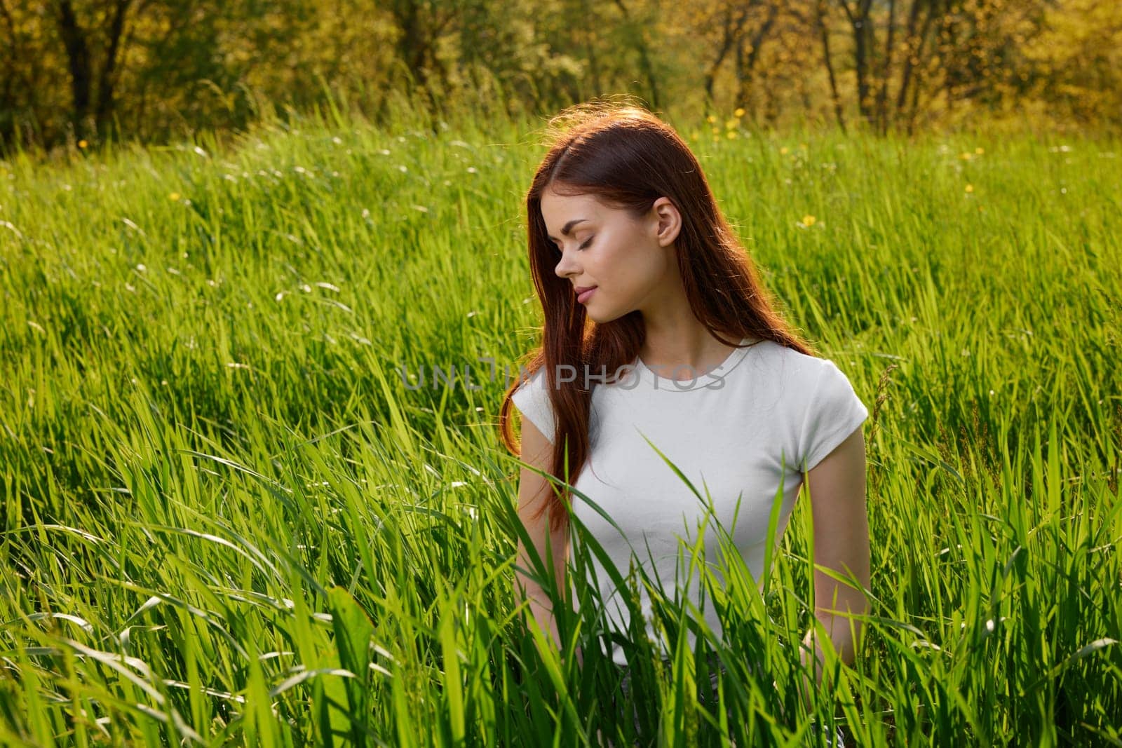 happy cheerful woman laying in green grass by Vichizh
