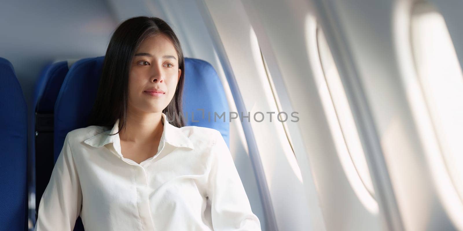 Beautiful Asian business woman happy and smile in luxury flight. working, travel, business concept by itchaznong