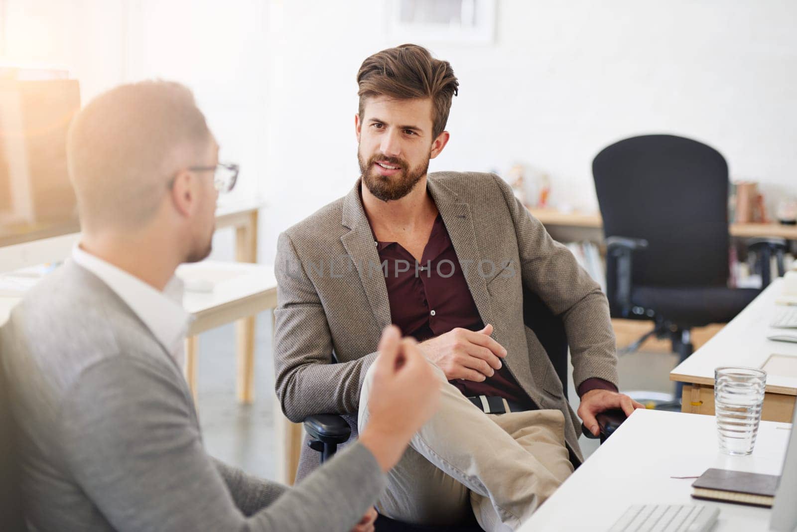 Great communication is key in the workplace. two businessmen having a discussion in the office