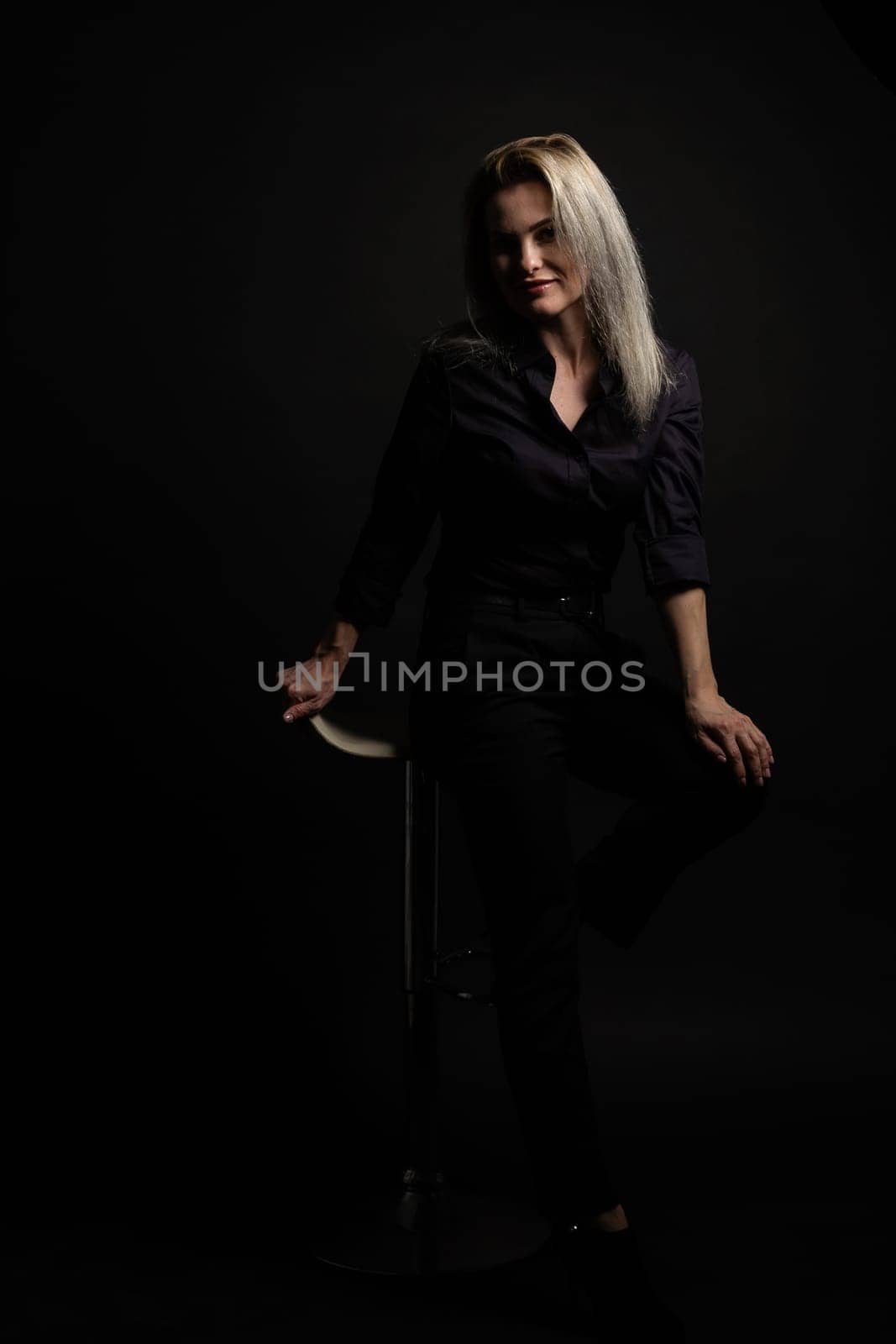 Blonde woman portrait, attractive adult girl in studio over black background