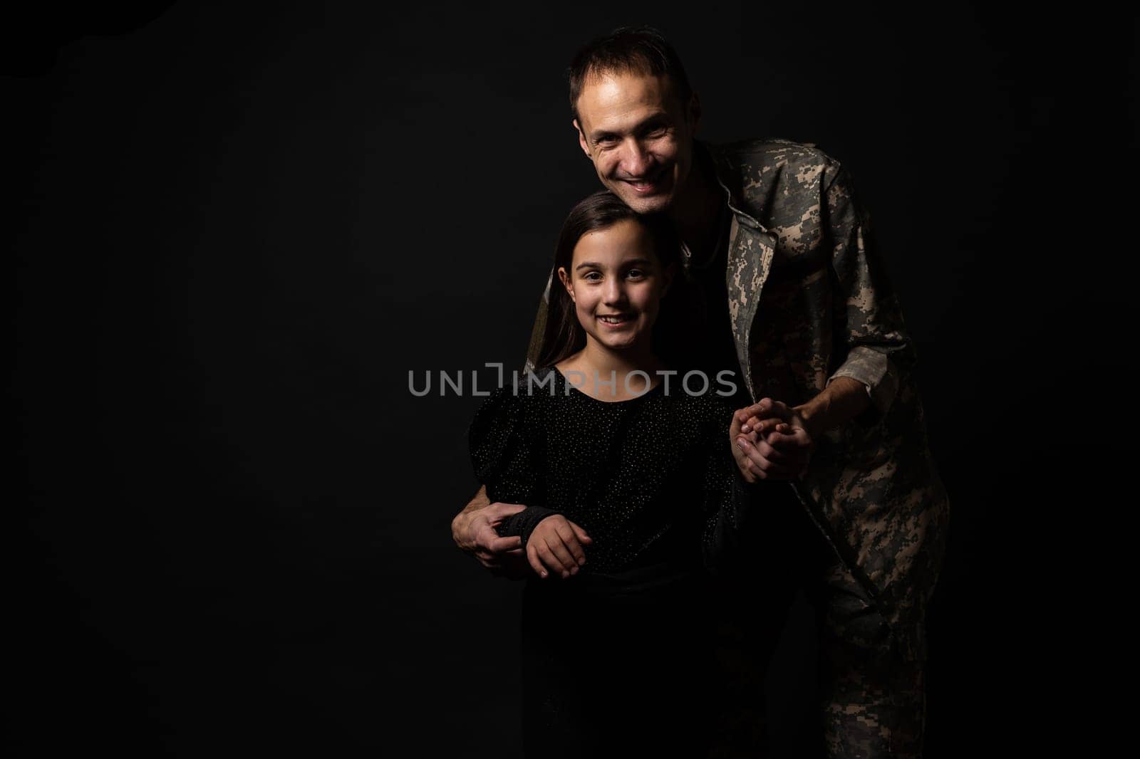 military man and daughter on a black background.