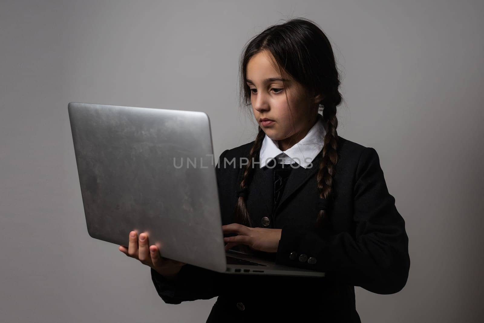 a girl in a black dress, Wednesday girl with a laptop.