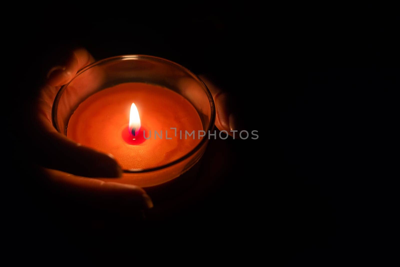 Close up of woman hand lighting candles in the dark night at home by Andelov13