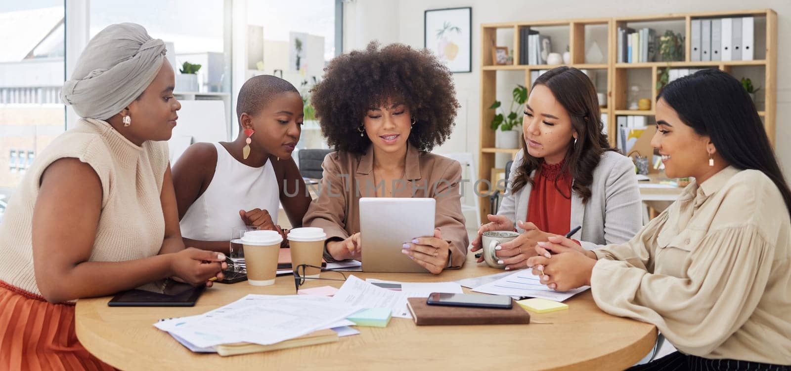 Teamwork, meeting and business women with tablet in office for brainstorming, discussion or planning. Technology, cooperation and group of people or employees with touchscreen for marketing strategy