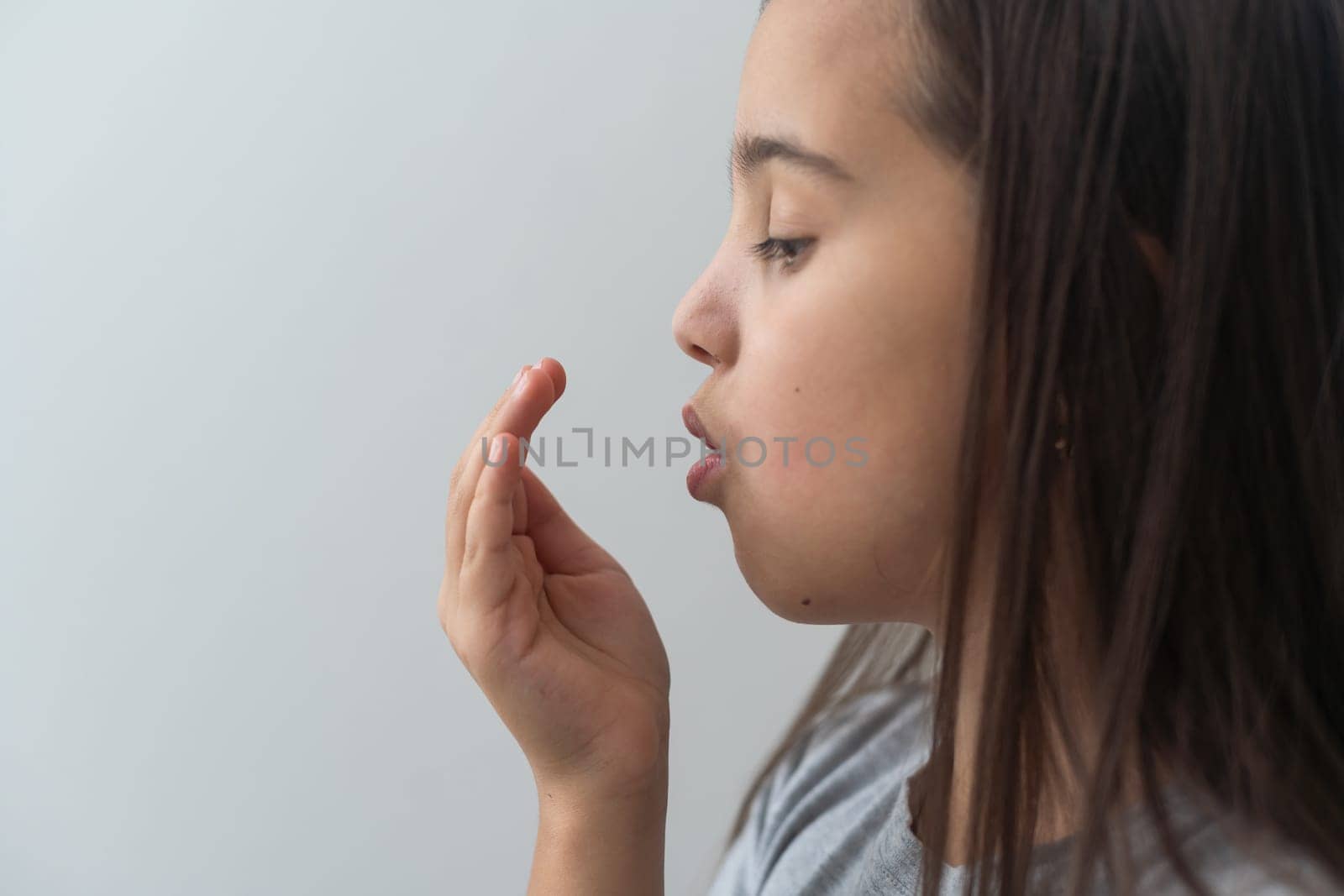 Little asian girl covering her mouth for smell her Bad breath. Oral health care problem. Dental health concept