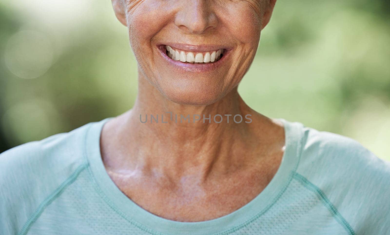 Smile, teeth and closeup with a senior woman outdoor in nature feeling happy, positive or carefree. Mouth, cheerful and dental with a mature female smiling happily outside in a garden during summer by YuriArcurs
