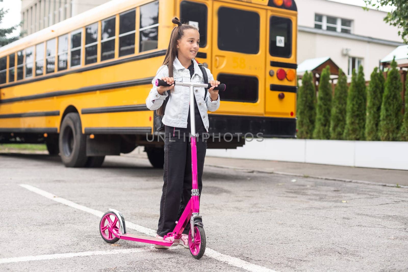 First day of school. Happy child girl elementary school student runs to class. concept back to school