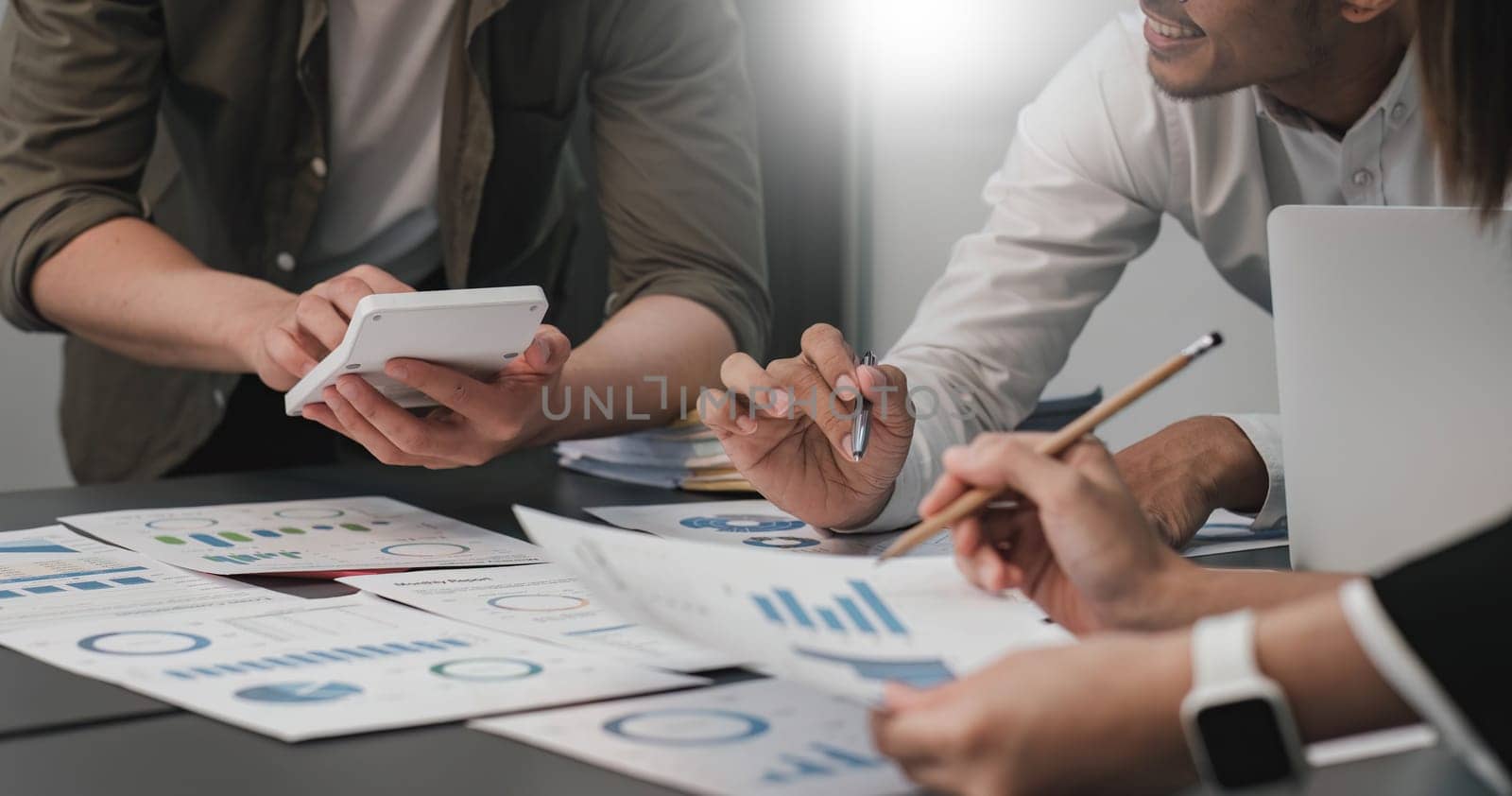 Business People Meeting using laptop computer,calculator,notebook,stock market chart paper for analysis Plans to improve quality next month. Conference Discussion Corporate Concept....