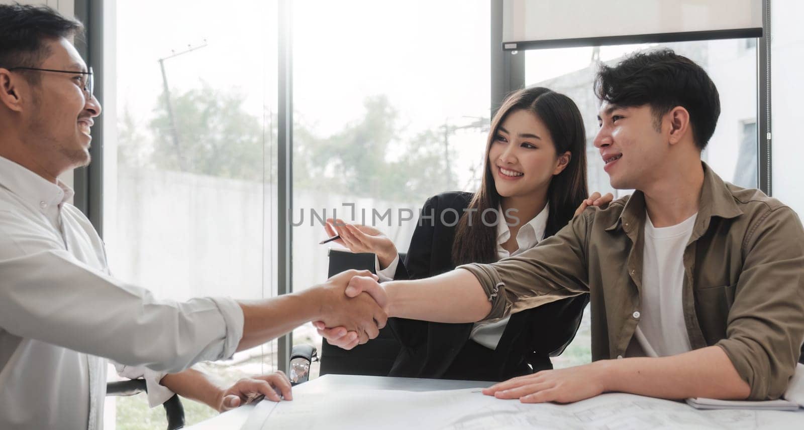 Success deal, Meeting and greeting for project of partner. Construction engineering, architect worker team or partnership hands shaking, handshake after agreement in office site, collaboration concept by wichayada