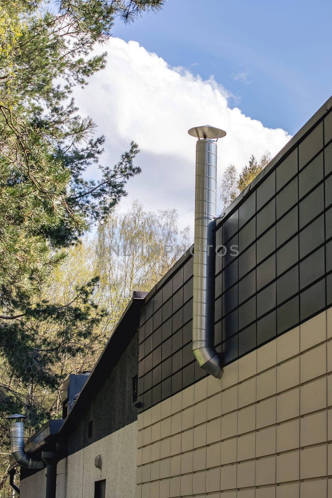 Pipe on the wall of a building in park