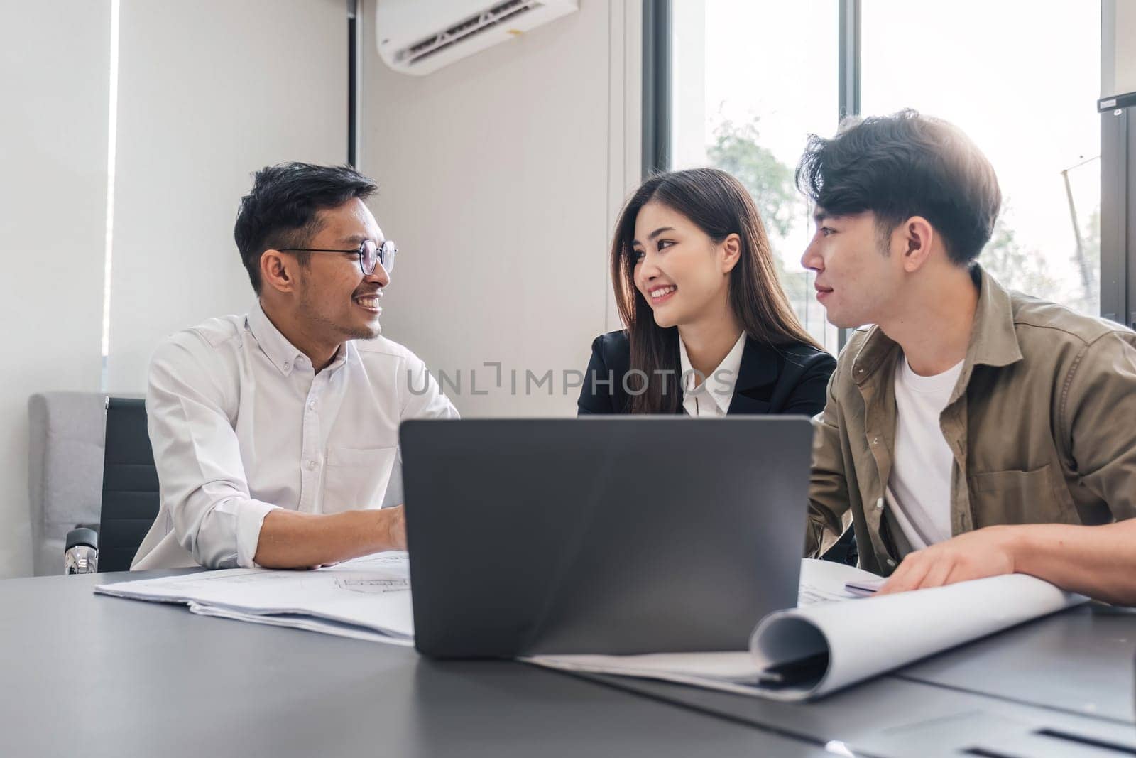 Civil engineer teams meeting working together wear worker helmets hardhat on construction site in modern city. Foreman industry project manager engineer teamwork. Asian industry professional team...