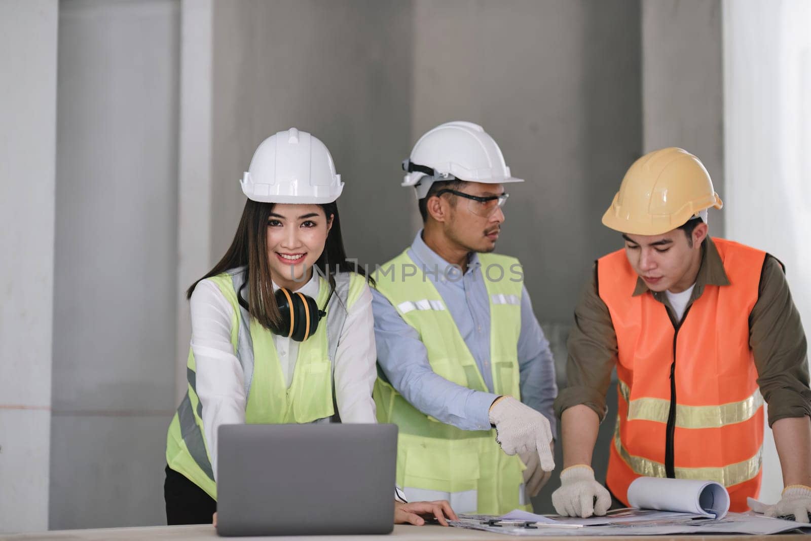 Engineers work as a team with blueprints for architectural plans. Engineer sketching construction project concept with architect equipment Architects talking at table Teamwork and construction concept.