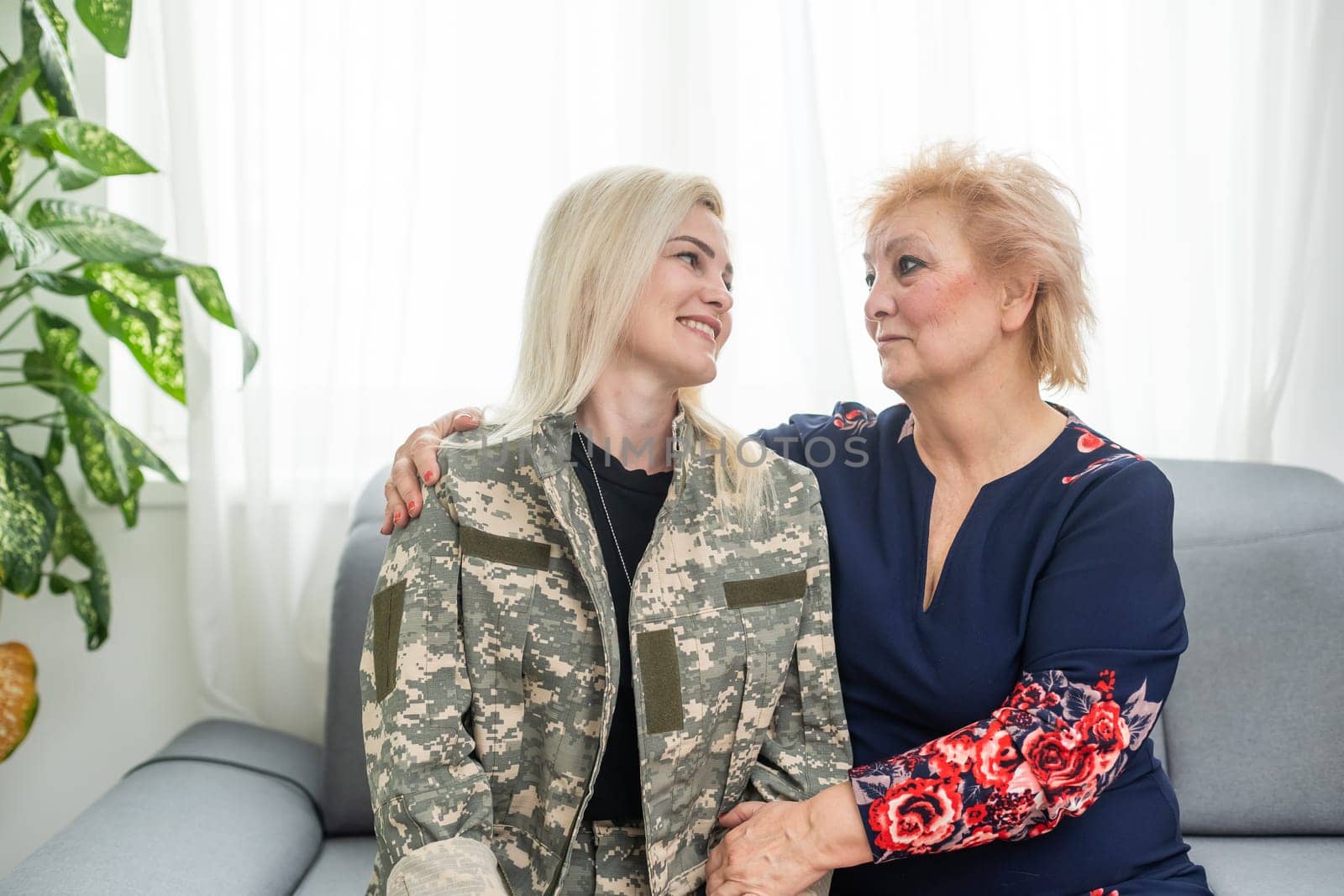 military woman and elderly mother at home.