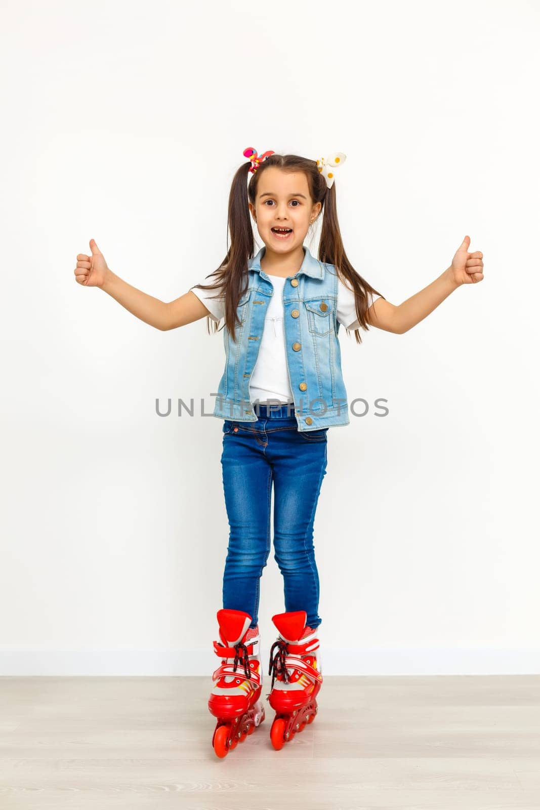 Cute girl in roller skates on a white background