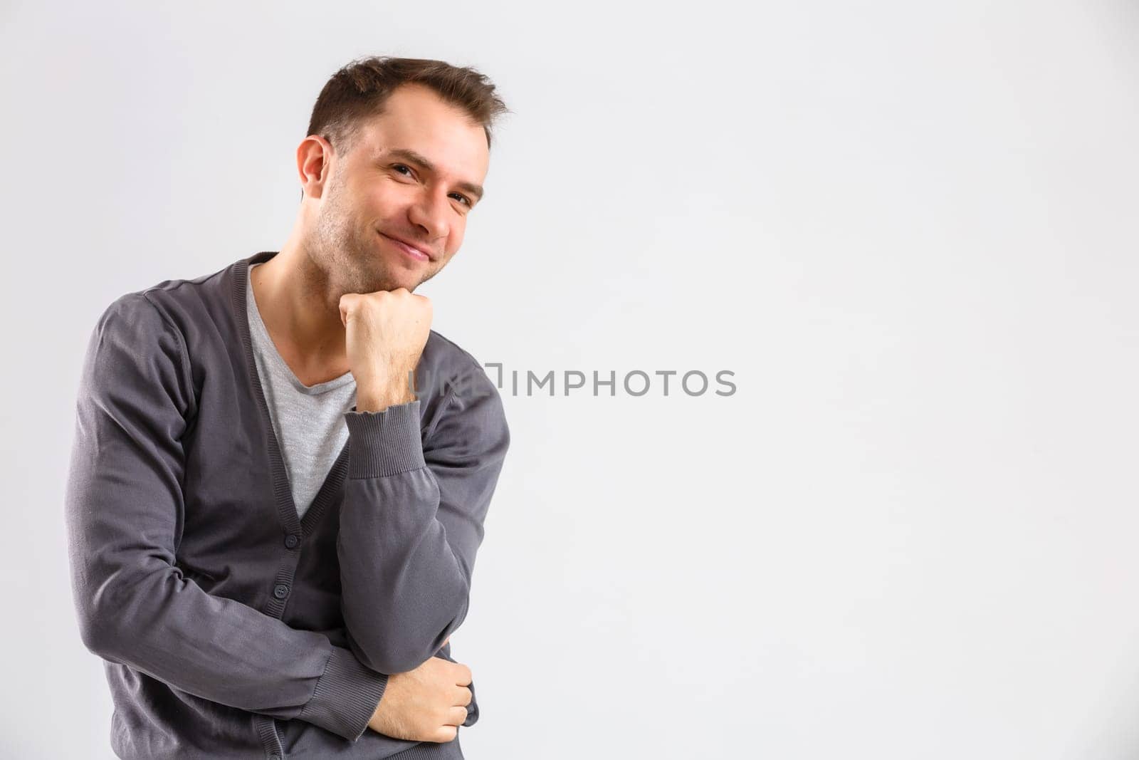 portrait emotional man standing near a wall on a gray background