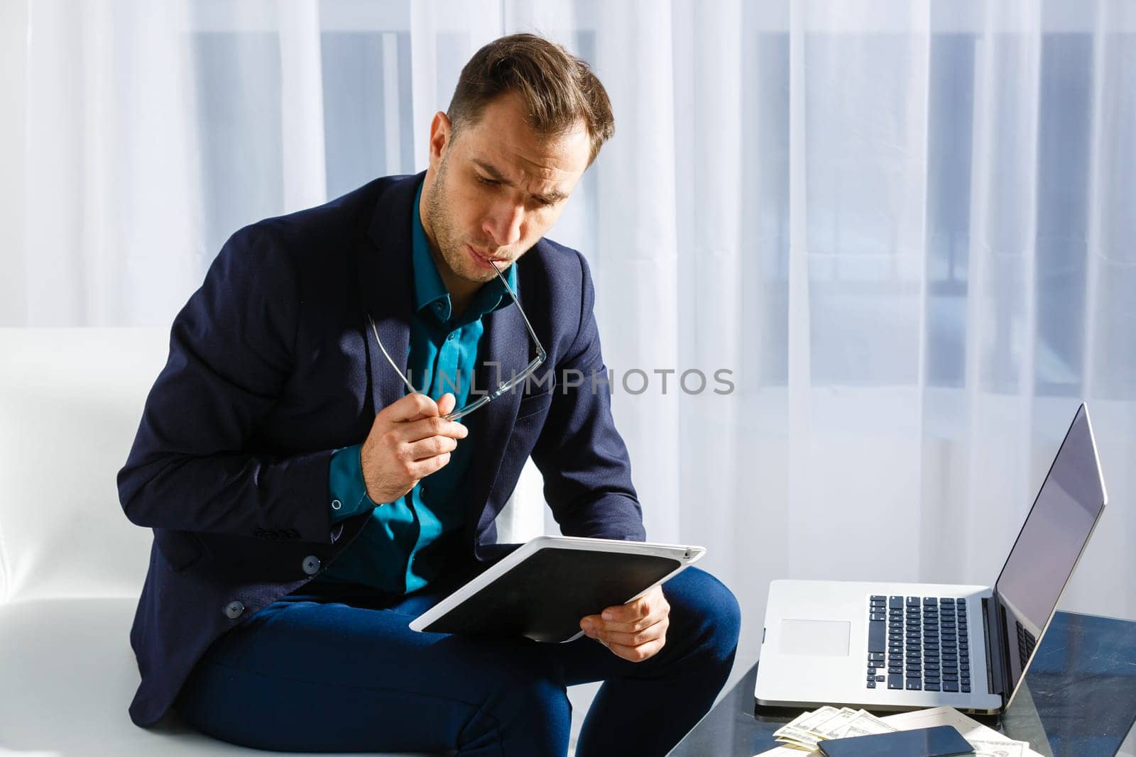 Business man working at office with laptop and documents on his desk, consultant lawyer concept by Andelov13