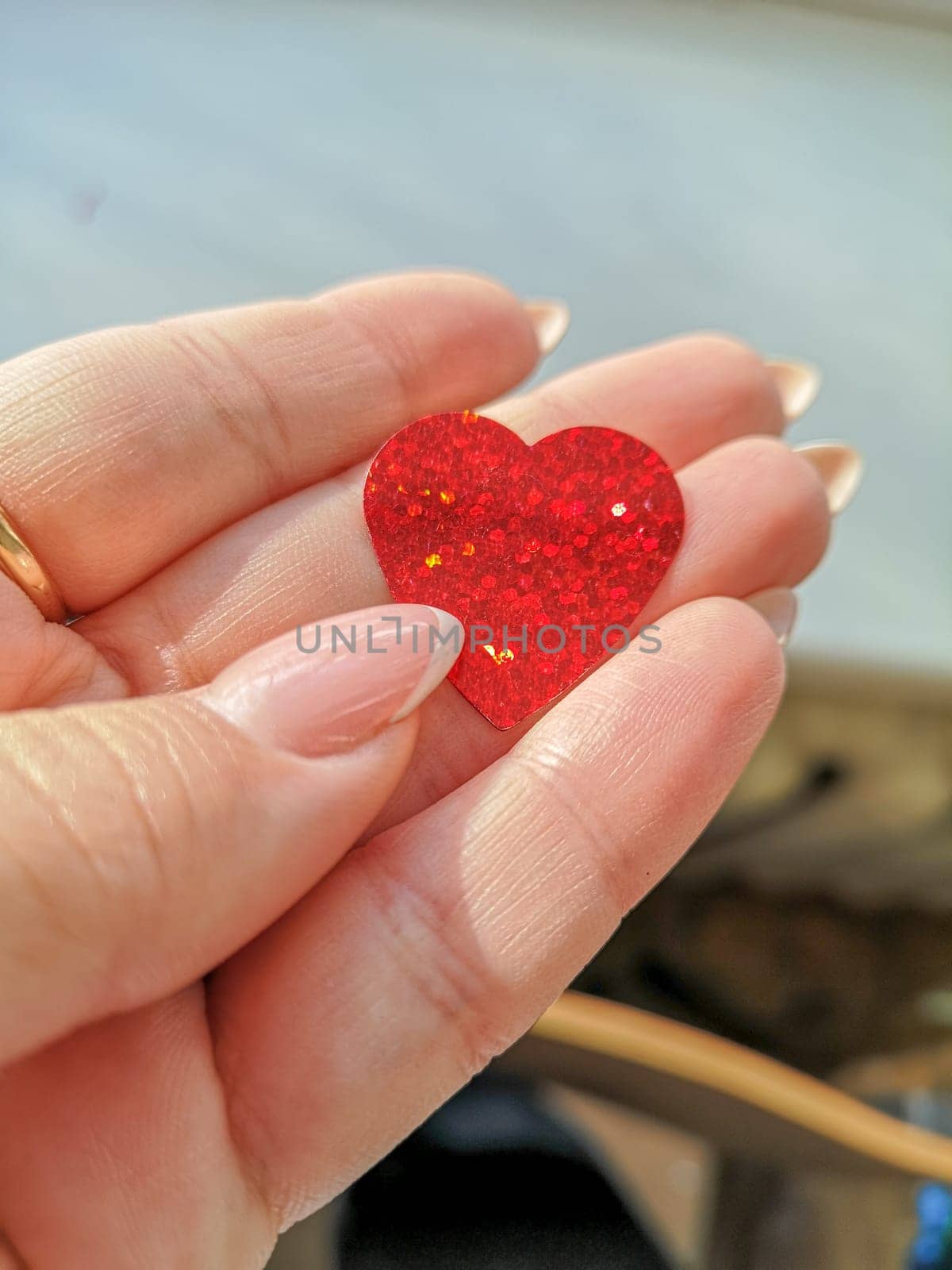 Shiny heart in a female hand. valentine's day concept. High quality photo