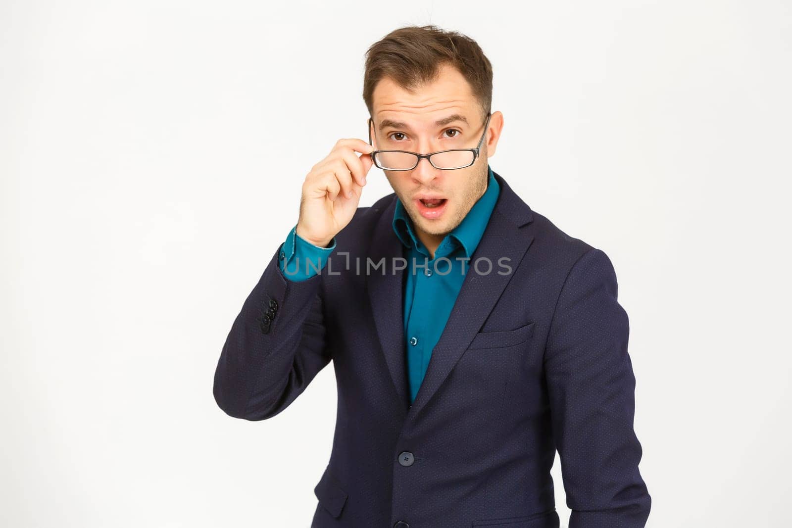 A view of a shocked young businessman isolated on white background