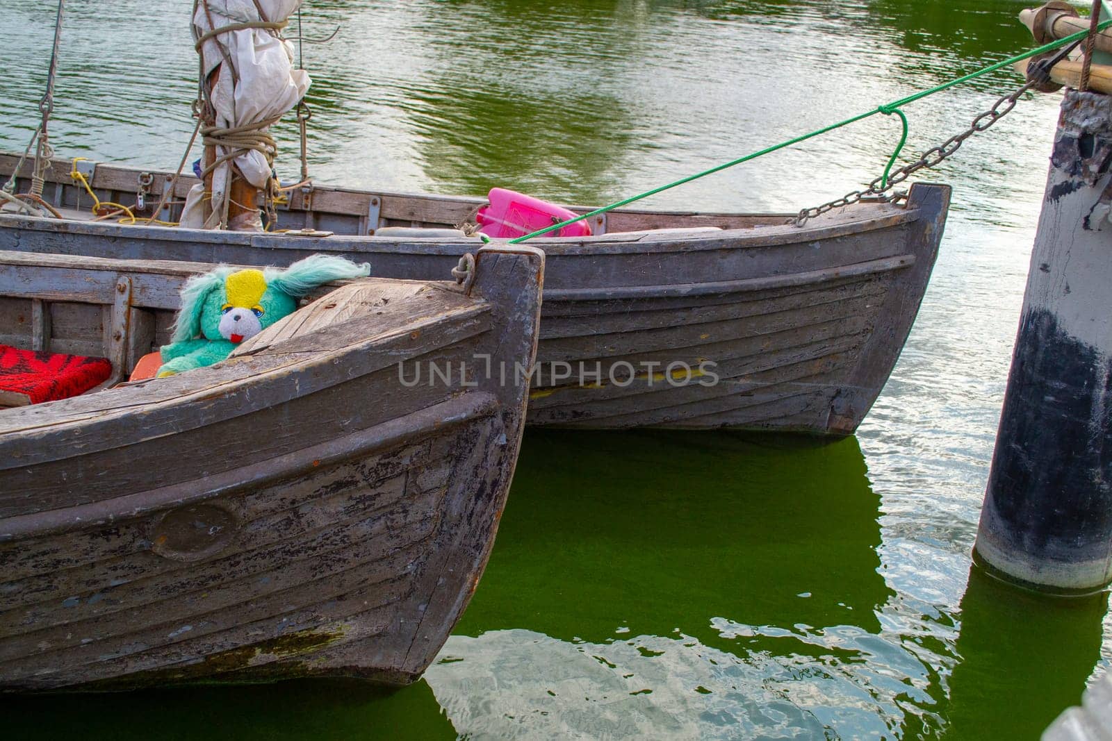 old wooden boats at the pier on green blooming water. High quality photo