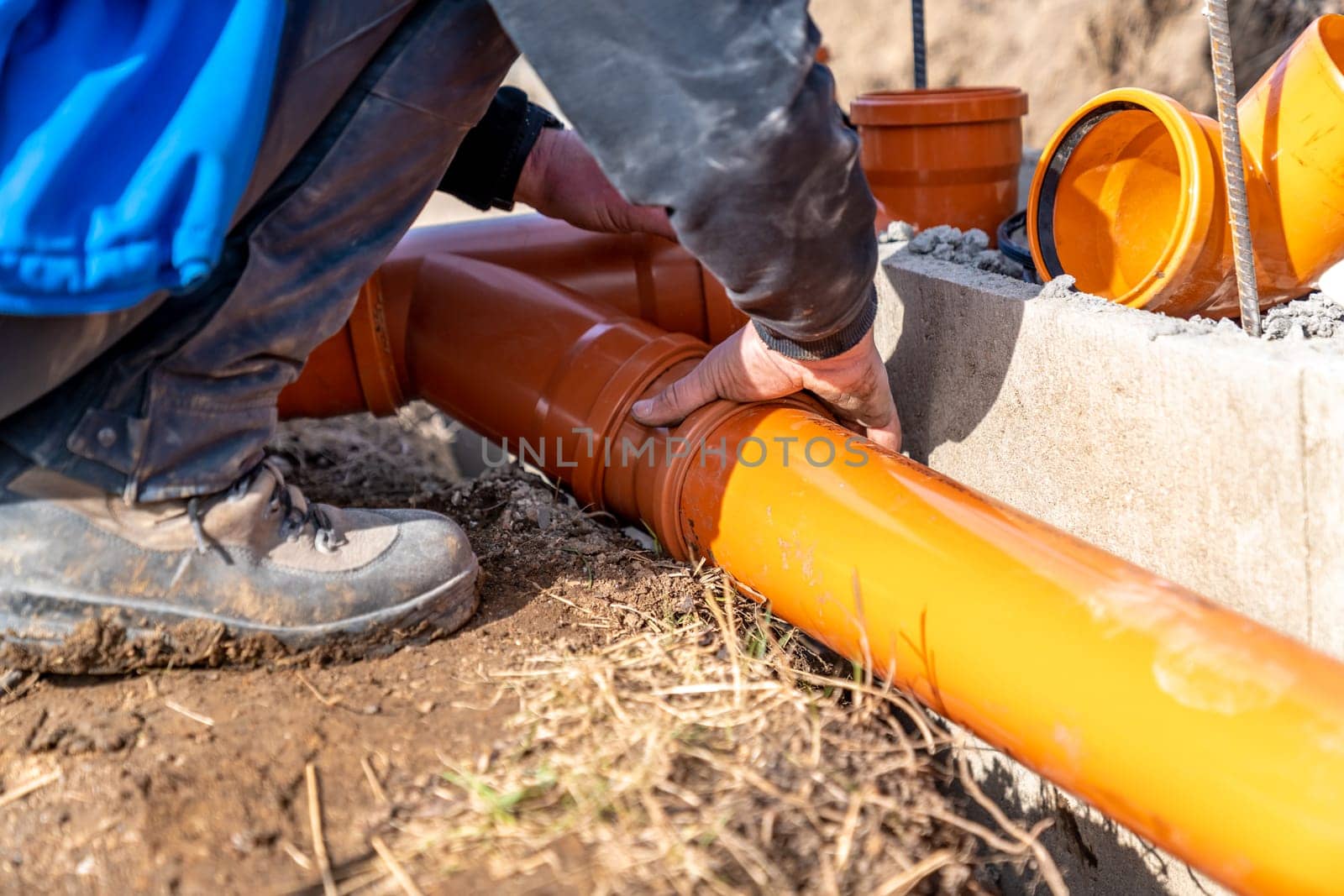 installation of a sewage plastic pipe during the construction of a house.