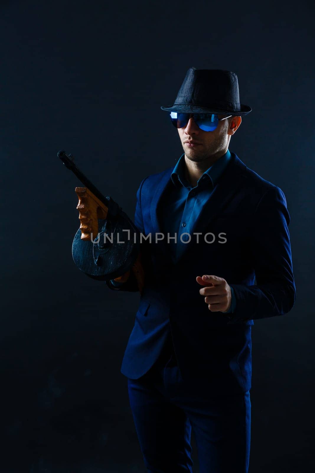 Mature Business Man Holding Gun on a dark background.