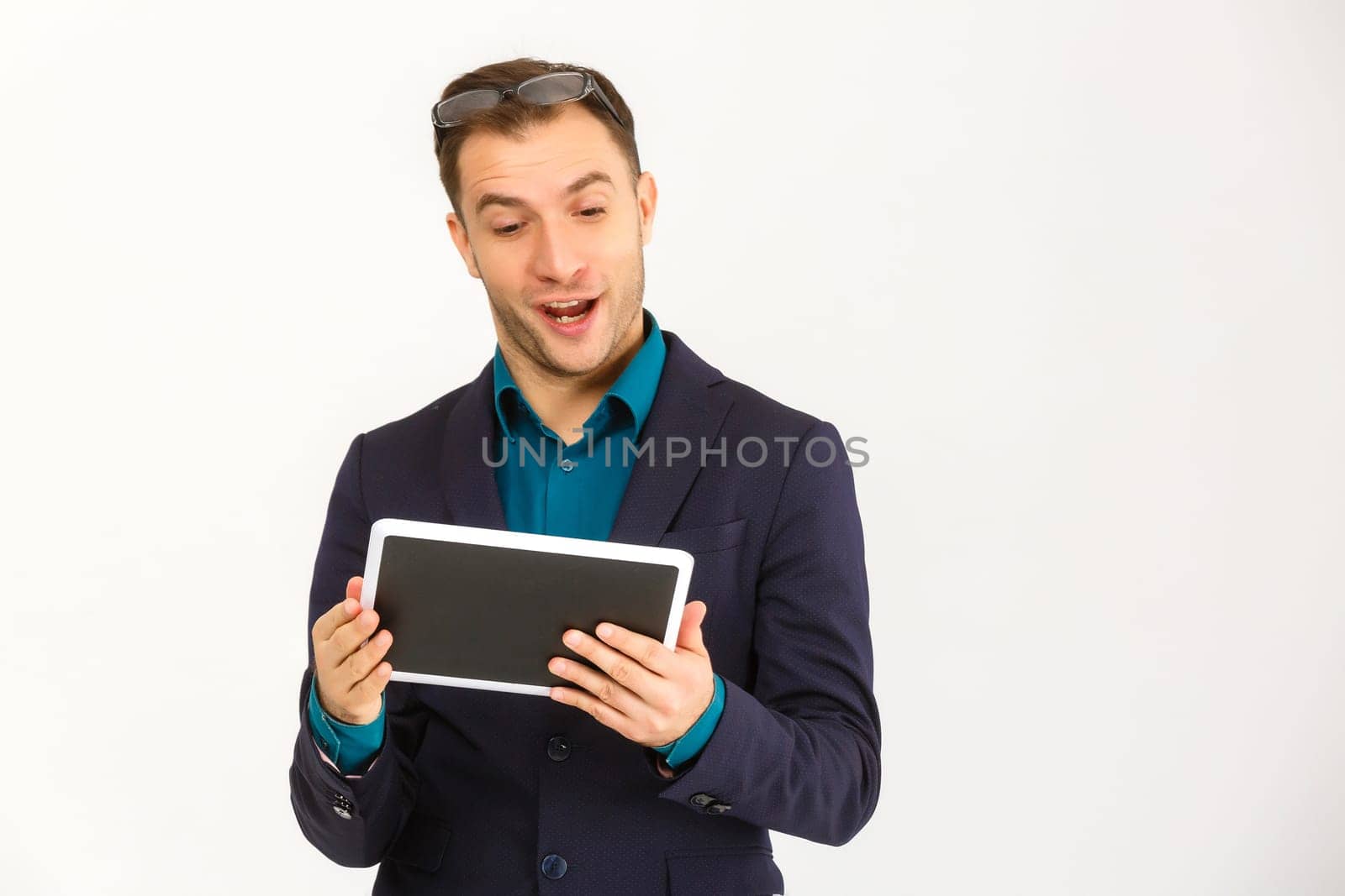 A view of a shocked young businessman isolated on white background
