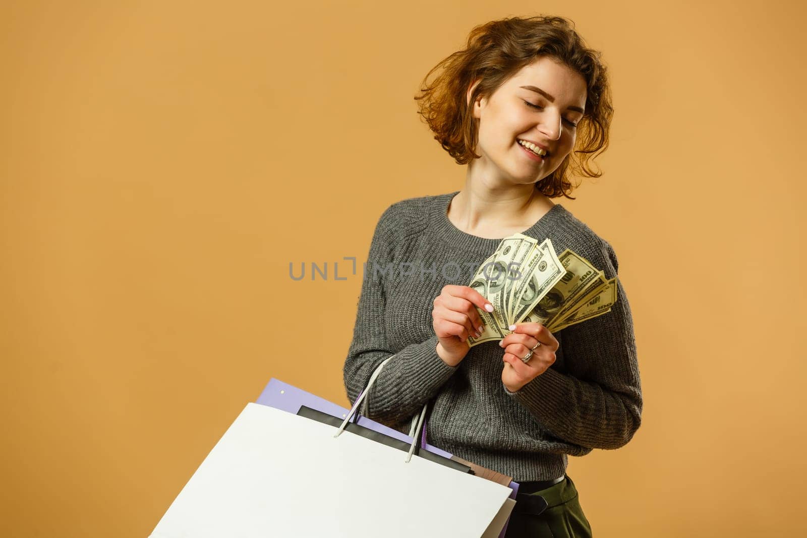Portrait of happy beautiful shopaholic woman carry shopping bags, advertising concept isolated banner background.