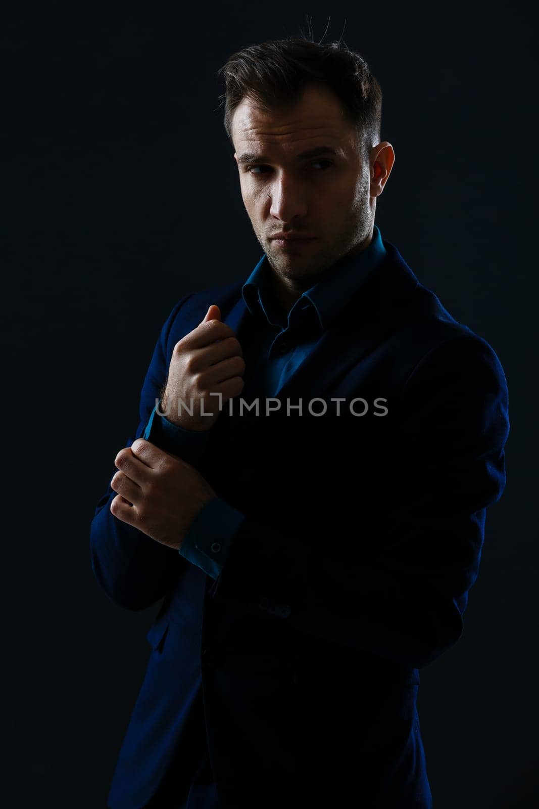 Happy smiling business man with crossed arms on black background