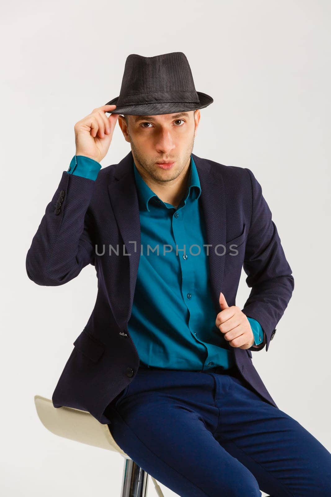 Confident middle-aged wealthy man dressed in retro style suit with hat.