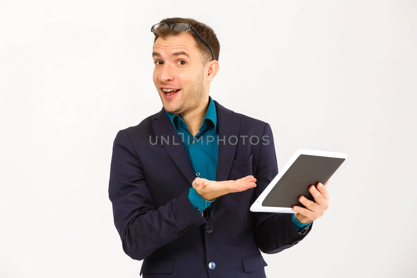 Cool businessman using electronic tablet on white background by Andelov13