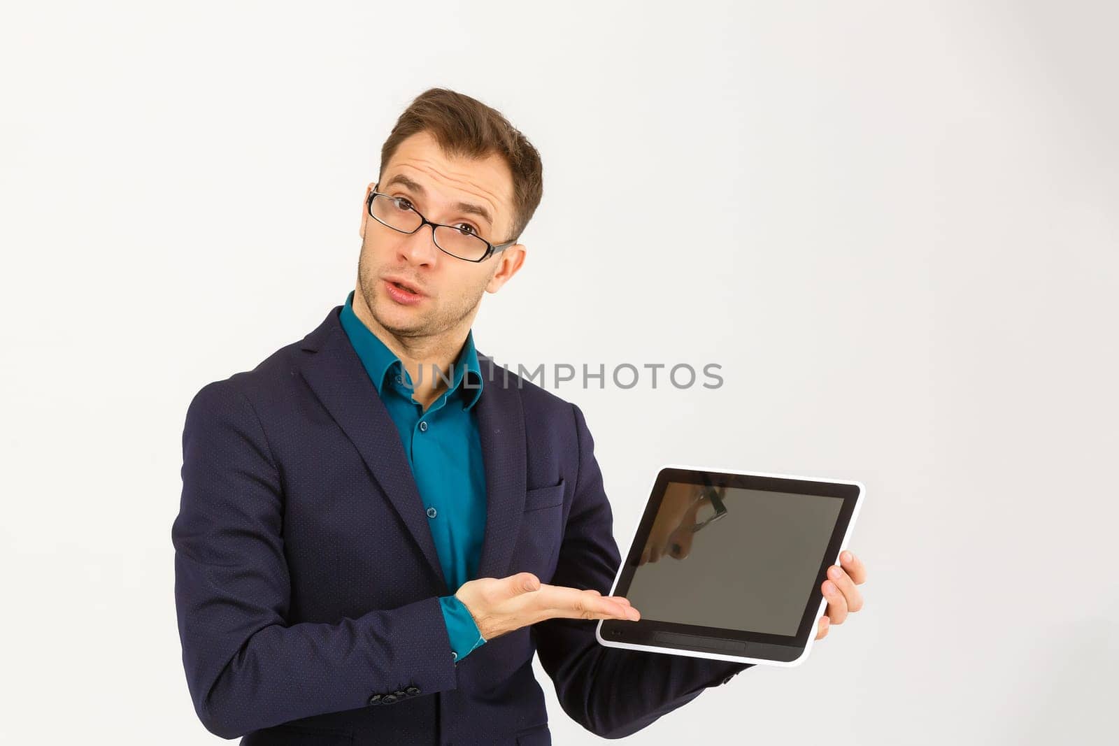 Cool businessman using electronic tablet on white background by Andelov13