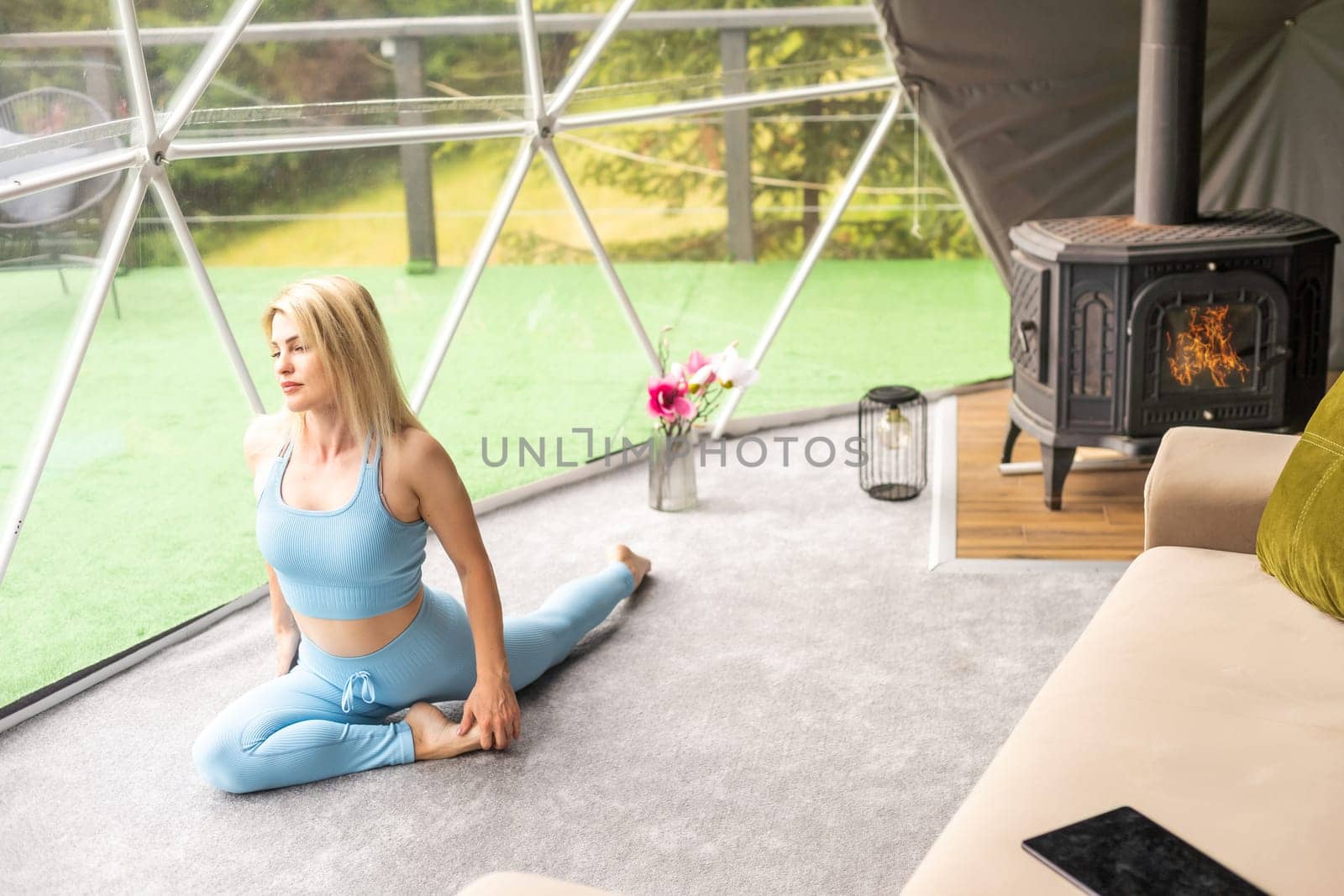 A woman is in a geo dome glamping tent. Glamping vacation lifestyle concept