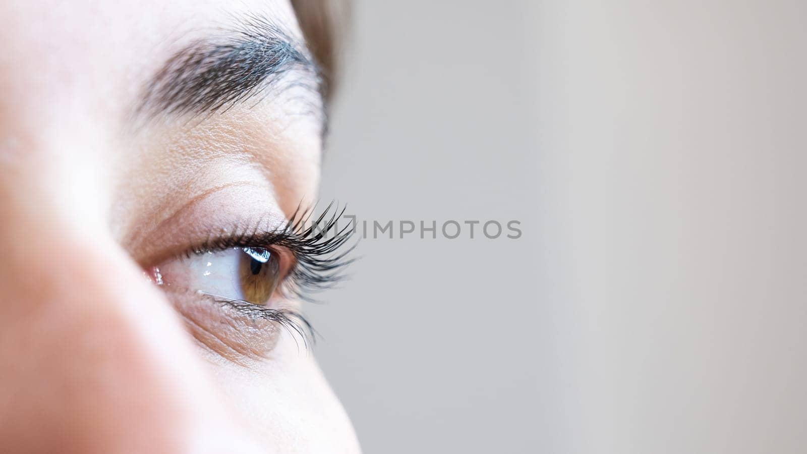 Close-up of a woman's eye after an eyelash lamination procedure