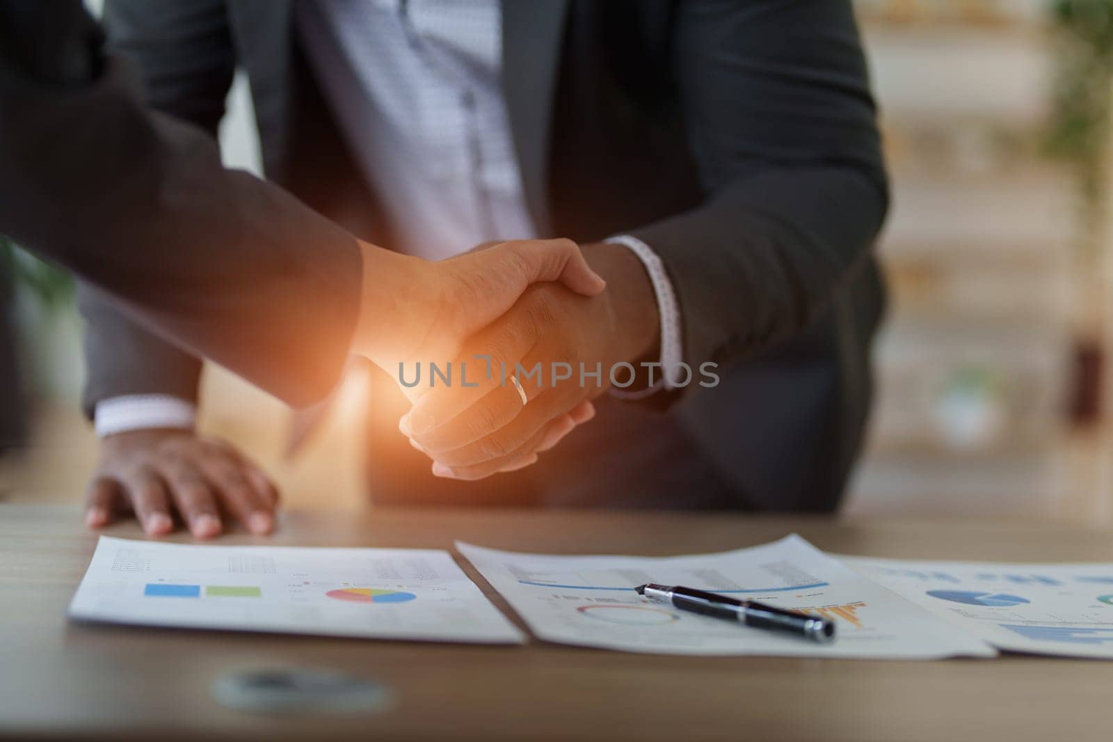 african american and asian people hand shaking successful corporate partnership deal welcoming opportunity in office agreement professional greeting meeting colleagues partners.