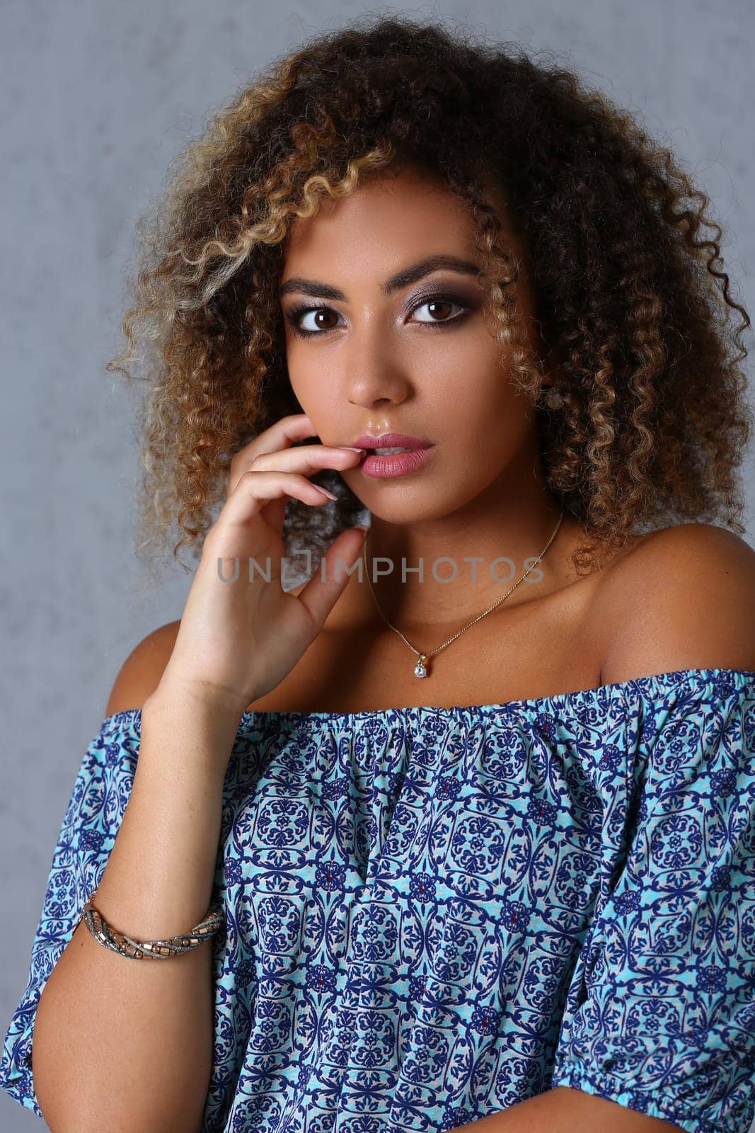 Beauty portrait of African American girl with evening makeup Smiling dreamy beautiful woman with curly hair