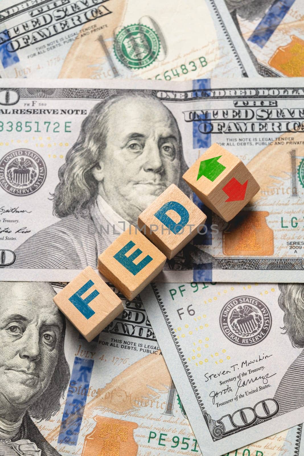 Wooden cubes with FED and up-down arrows over 100 usd. Fed rate hike concept to curb inflation by Sonat