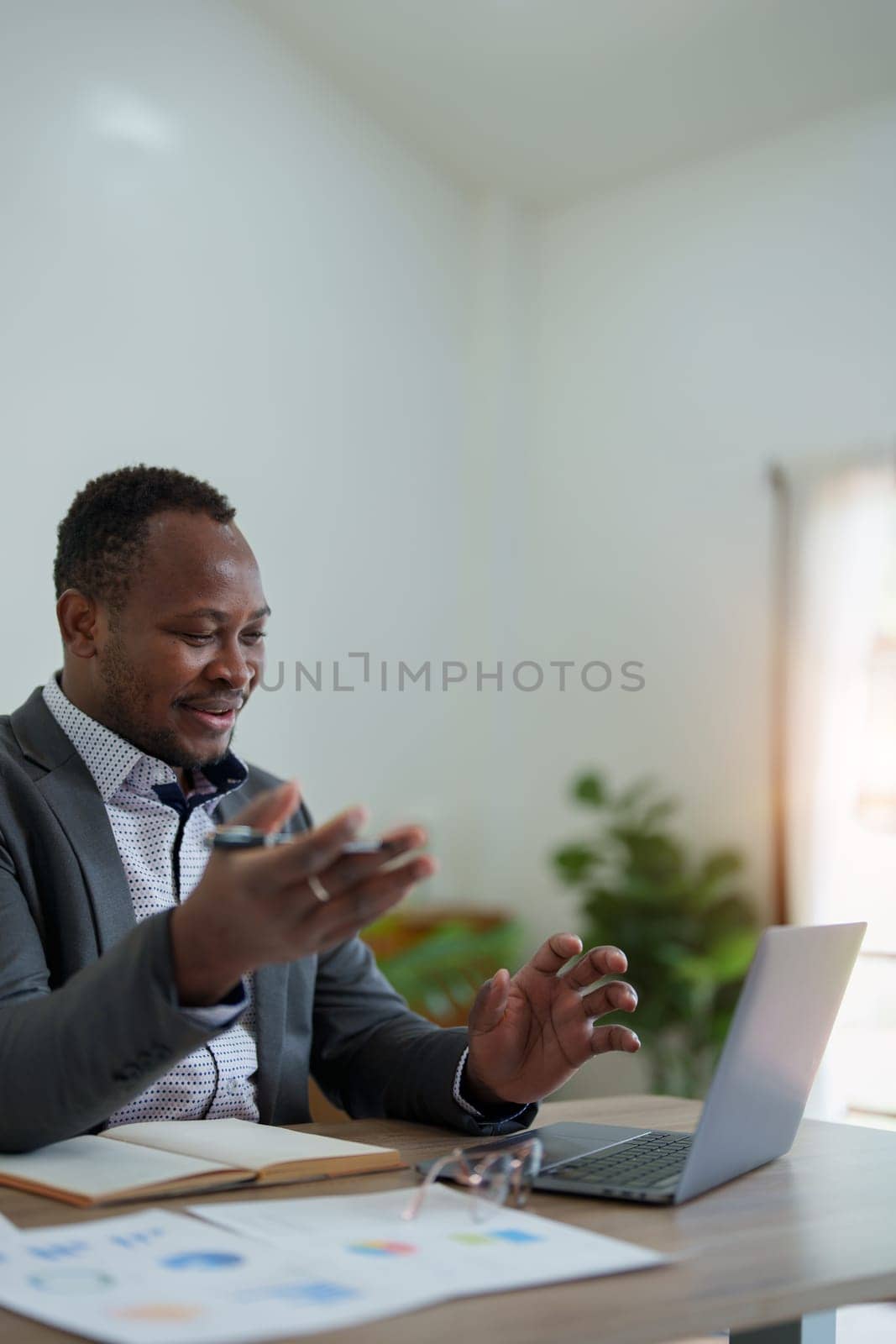 african american man, video call and laptop, wave hello and meeting, consulting or internet planning in startup company. Happy worker greeting for online meeting, computer webinar by Manastrong