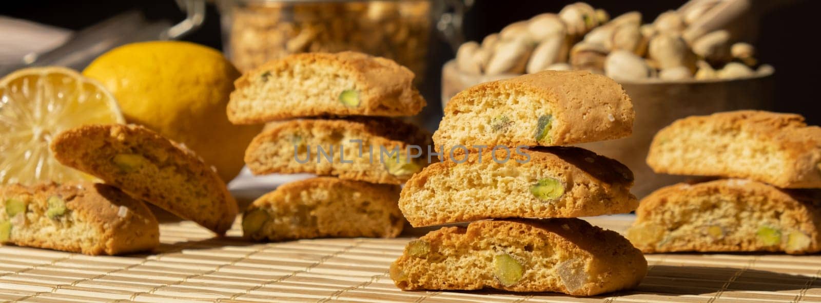 Biscotti Cantuccini Cookie Biscuits with pistachios and lemon peel Shortbread. Healthy eating food. Homemade fresh Italian cookies cantucci stacks and organic pistachios nuts. Vegan dieting vegetarian. Nutrition