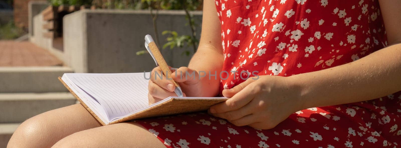 Unrecognizable Young woman in red dress Writing Gratitude Journal on wooden bench. Today I am grateful for. Self discovery journal, self reflection creative writing, self growth personal development concept. Self care wellbeing spiritual health, being mindful, holistic health practices habits mindfulness