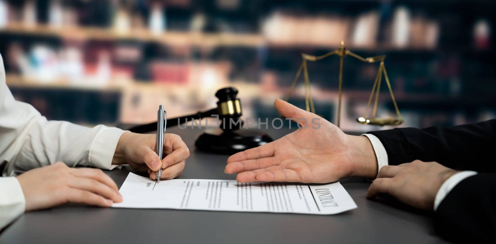 Lawyer signing contract, professional lawyer in law firm library drafting legal document or contract agreement ensuring lawful protection for client's dispute as fairness advocate concept. Equilibrium