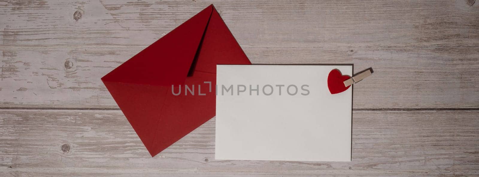 Banner Greeting or invitation card mock up with red envelope on wooden background. Romantic Small hearts Valentine day. Blank paper card copy space for your text. Holiday morning. Top view, flat lay minimalist aesthetic luxury bohemian business branding concept
