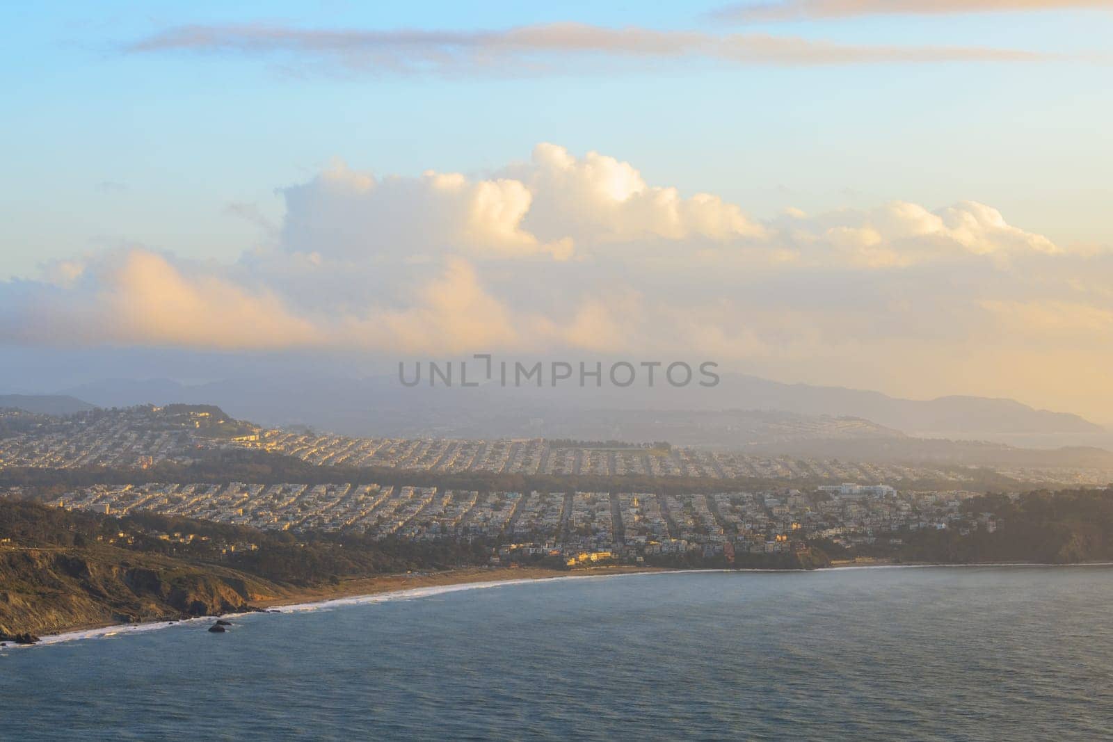 Sunset glow over rows of houses in residential area of coastal San Francisco. High quality photo